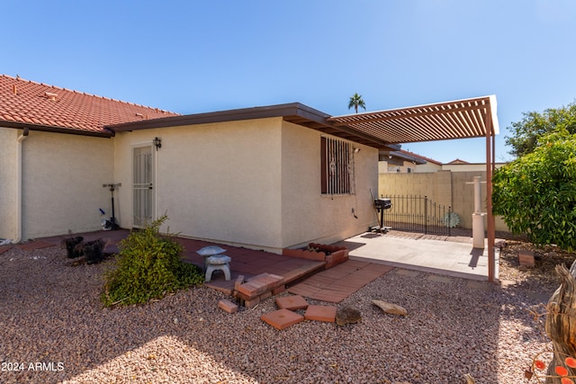 view of side of property with a pergola and a patio