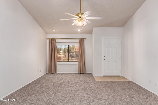 unfurnished room featuring a textured ceiling, ceiling fan, and light carpet