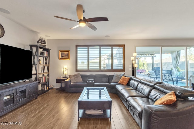 living area featuring a ceiling fan and wood finished floors