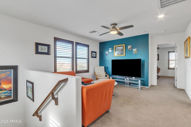 living room featuring ceiling fan, carpet, and visible vents