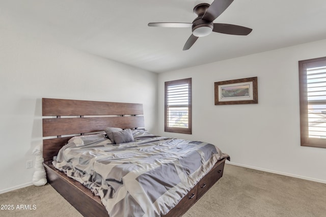 carpeted bedroom featuring baseboards and a ceiling fan