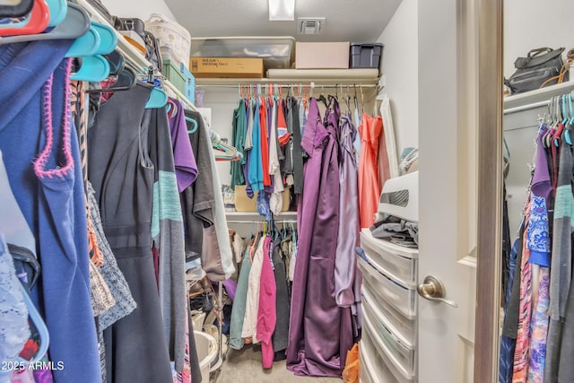 walk in closet with carpet flooring