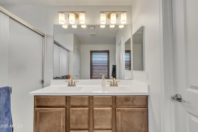 full bathroom with visible vents, a sink, and double vanity