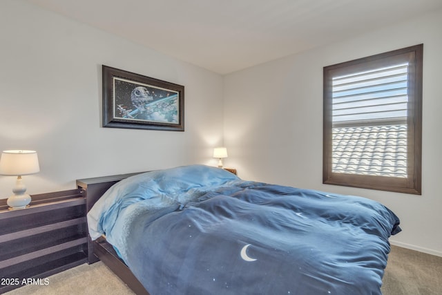 carpeted bedroom featuring multiple windows and baseboards