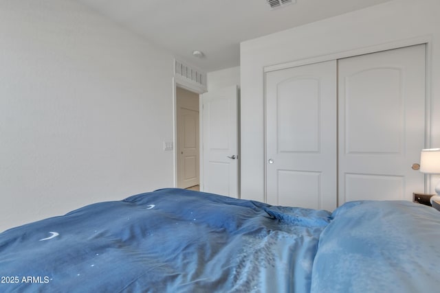 bedroom featuring a closet and visible vents