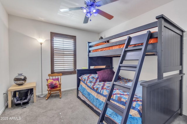 bedroom with ceiling fan, carpet flooring, and baseboards