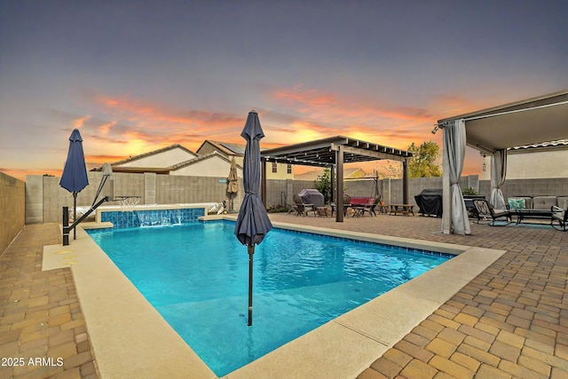 pool at dusk with a patio area, a fenced backyard, a fenced in pool, and a pergola