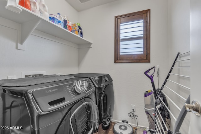 laundry room featuring laundry area, visible vents, and washer and clothes dryer