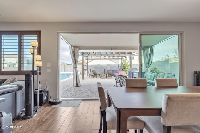 dining space featuring wood finished floors and a wealth of natural light