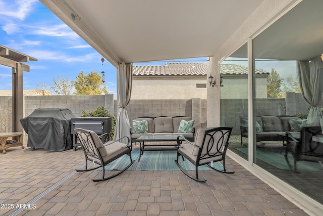 view of patio / terrace featuring a grill, an outdoor living space, and fence