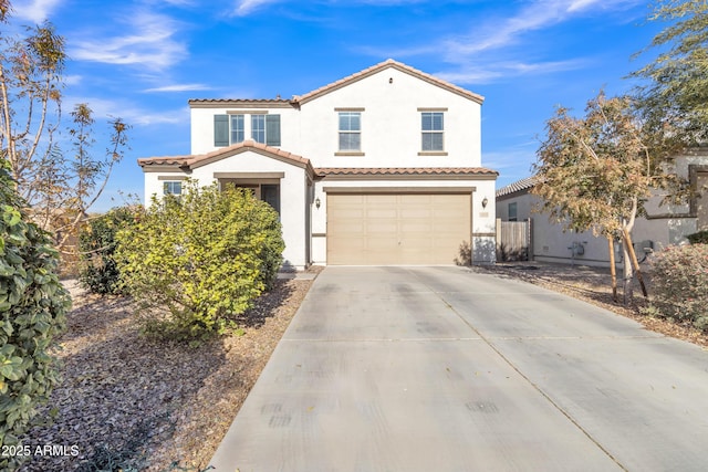 mediterranean / spanish house with a garage, driveway, a tiled roof, fence, and stucco siding