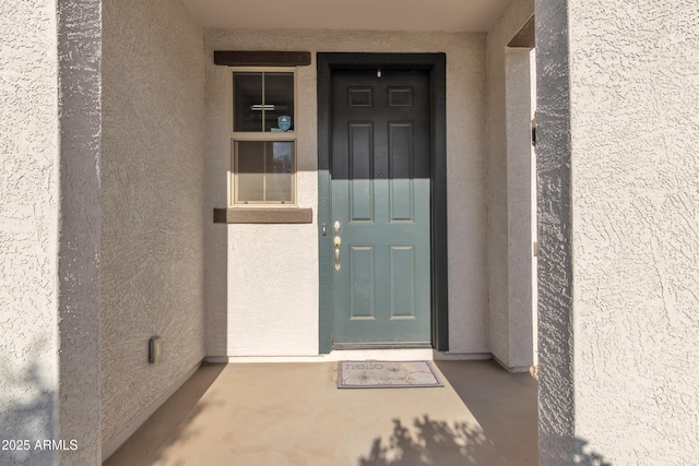 doorway to property with stucco siding