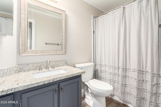 full bathroom with wood finished floors, vanity, toilet, and crown molding