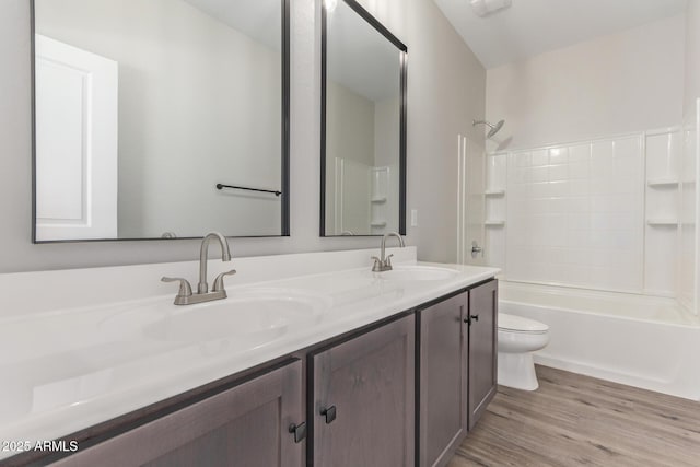 full bathroom with shower / bathing tub combination, vanity, toilet, and hardwood / wood-style floors