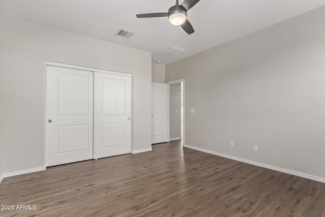 unfurnished bedroom featuring dark wood-type flooring, ceiling fan, and a closet