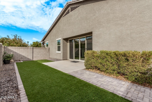 rear view of property featuring a patio and a yard