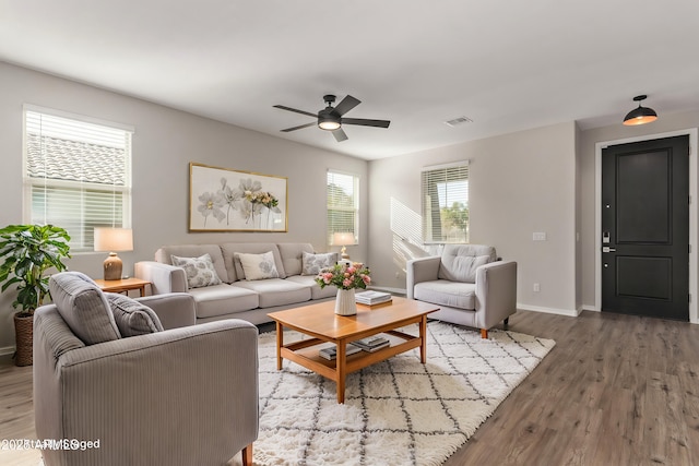 living room with ceiling fan and hardwood / wood-style floors