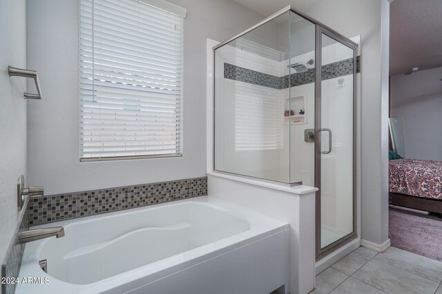 bathroom with tile patterned flooring and independent shower and bath