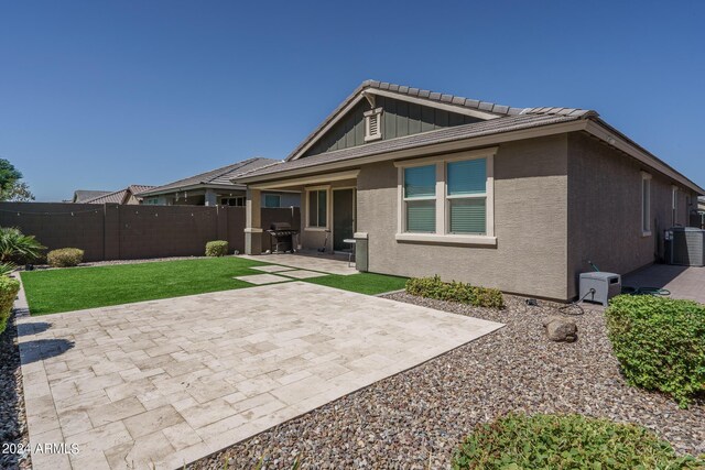 back of house with a patio and central AC