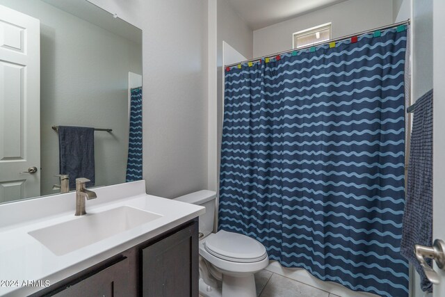 bathroom with tile patterned flooring, curtained shower, vanity, and toilet