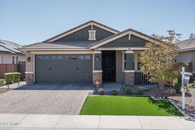 view of front of house with a porch, a garage, and a front yard