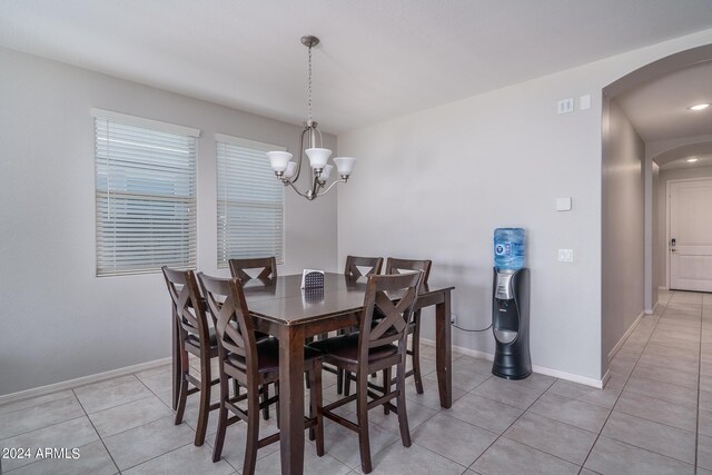 dining room featuring a notable chandelier and light tile patterned floors