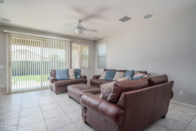 tiled living room featuring ceiling fan