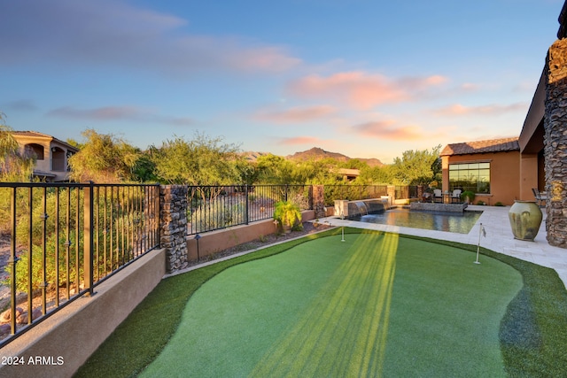 yard at dusk with a mountain view and a patio