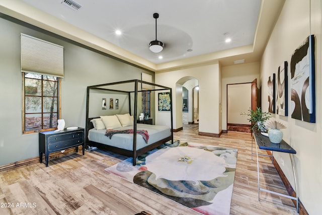 bedroom with light wood-type flooring and ceiling fan