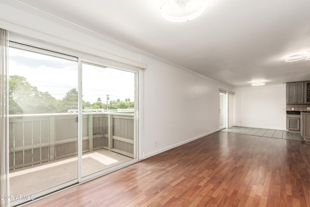 6767 N 7th St Unit 230, Phoenix, AZ 85014 - unfurnished room featuring wood finished floors, crown molding, and baseboards