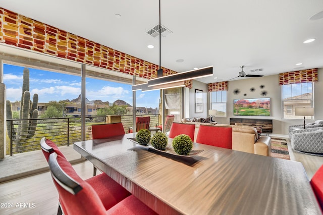 dining space featuring light hardwood / wood-style floors and ceiling fan