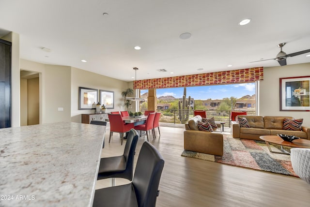 dining room with hardwood / wood-style floors and ceiling fan