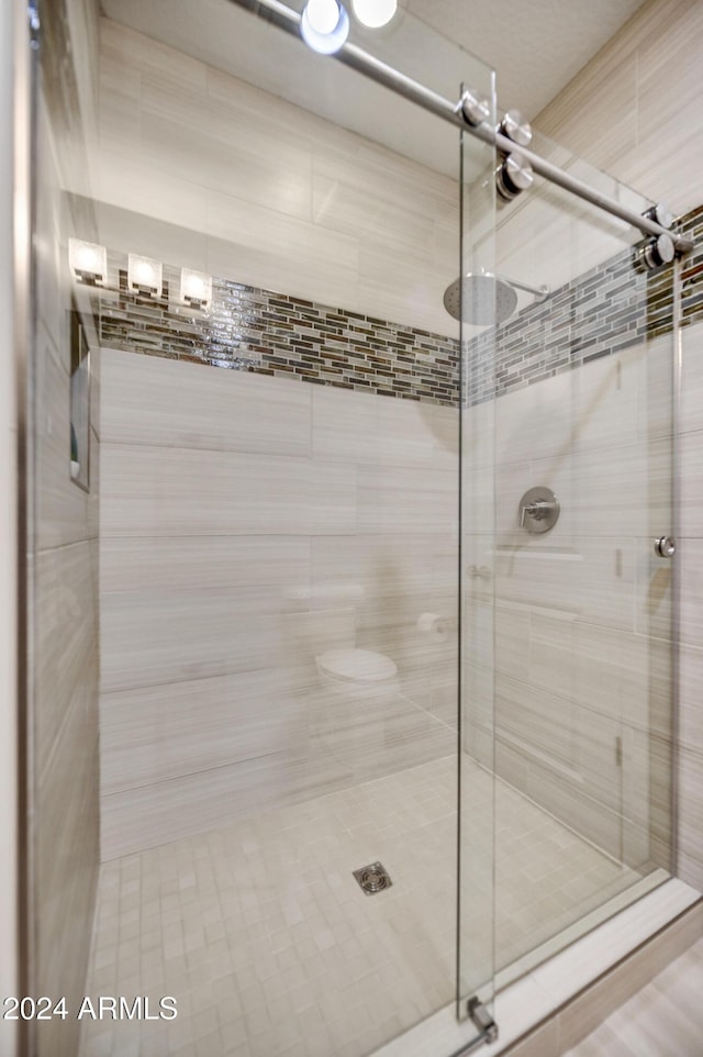 bathroom with a shower with shower door