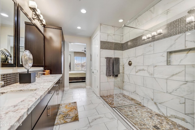 bathroom with vanity and tiled shower