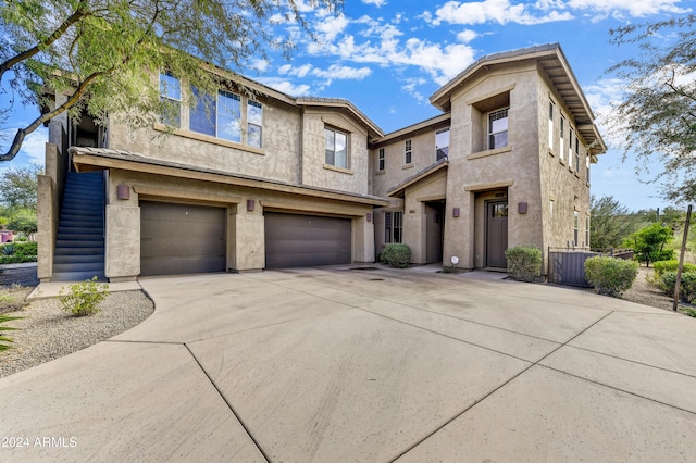 multi unit property featuring cooling unit and a garage