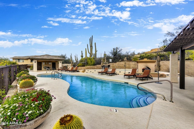 view of pool with an outbuilding and a patio area