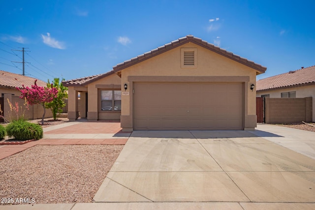 ranch-style house featuring stucco siding, driveway, a tile roof, and fence
