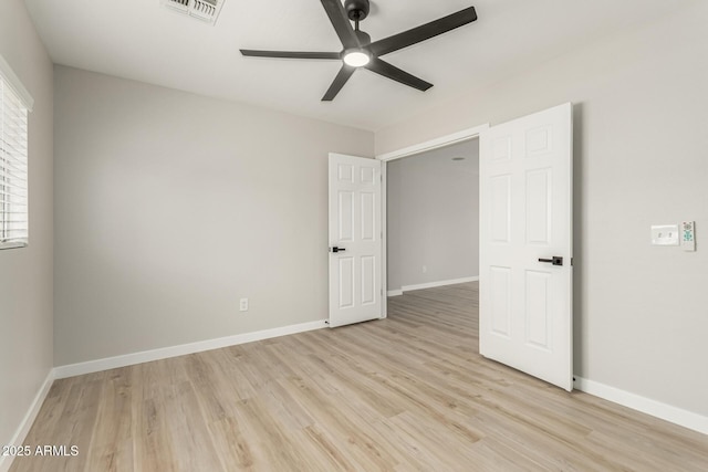 unfurnished bedroom featuring baseboards, visible vents, and light wood-style flooring
