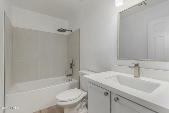 bathroom with visible vents, wood finished floors, vanity, toilet, and bathing tub / shower combination
