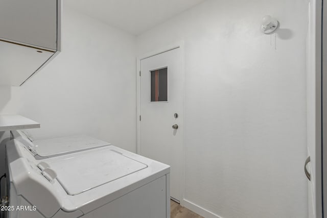 washroom featuring laundry area, washer and clothes dryer, and light wood-style floors