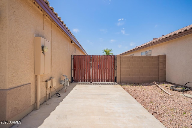 view of patio with fence and a gate