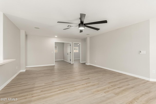 spare room featuring light wood-style floors, a ceiling fan, baseboards, and recessed lighting