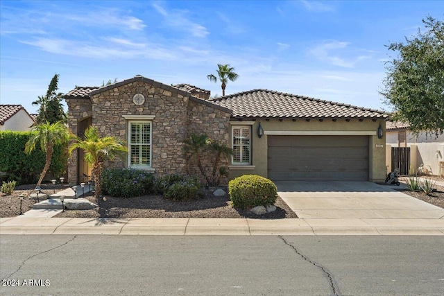 mediterranean / spanish-style house with a garage