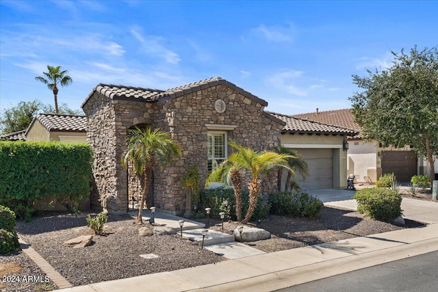 mediterranean / spanish house featuring a garage