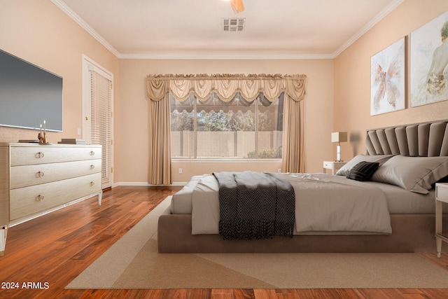 bedroom featuring ornamental molding and hardwood / wood-style floors