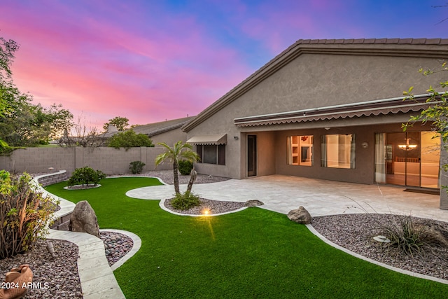 yard at dusk with a patio