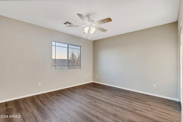 spare room featuring dark hardwood / wood-style floors and ceiling fan