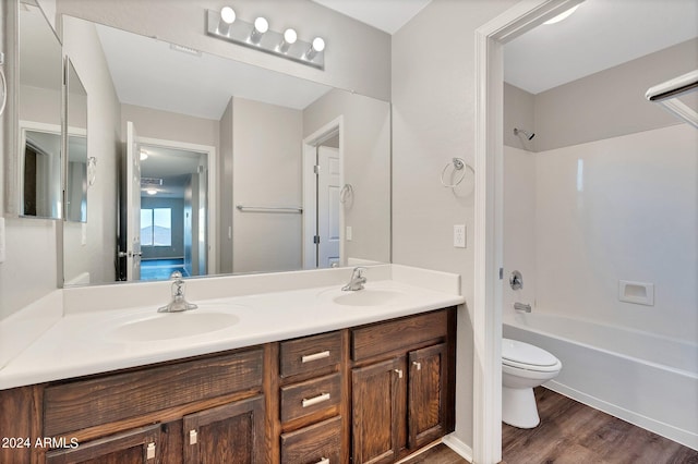 full bathroom featuring vanity, toilet, shower / bathing tub combination, and hardwood / wood-style floors