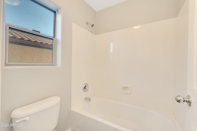 bathroom featuring shower / bathing tub combination and toilet