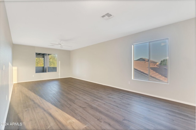 unfurnished room featuring dark hardwood / wood-style floors and ceiling fan